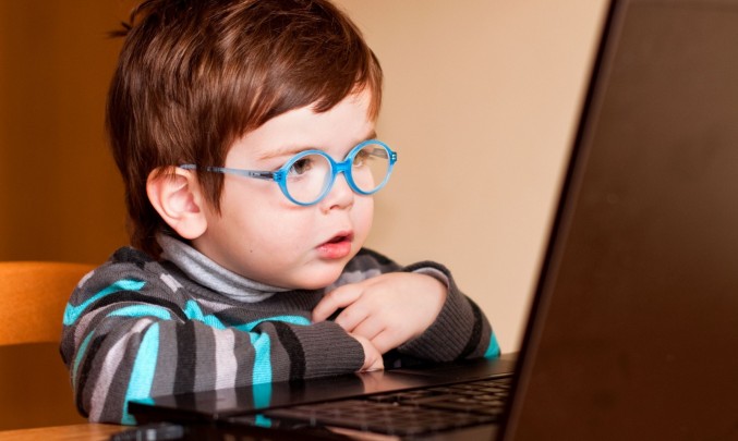 dítě s brýlemi před laptopem